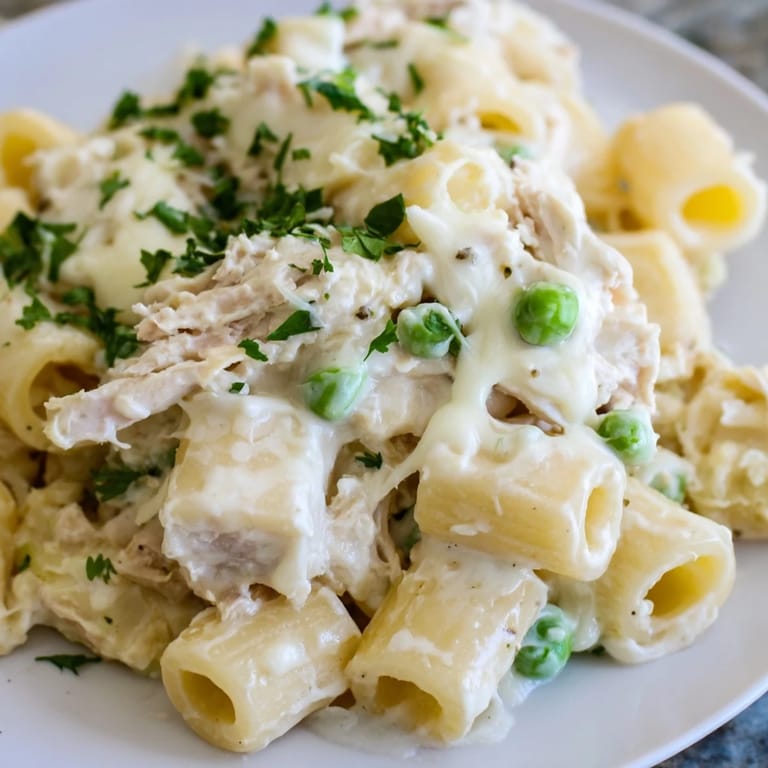 A close-up shot of the savory Slow Cooker Chicken Alfredo Pasta Bake, perfect for a family dinner.