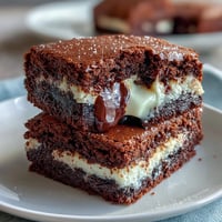 Cream cheese stuffed brownie mix cookies with rich, fudgy centers and gooey chocolate chips.