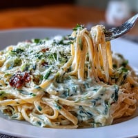 Creamy cabbage Alfredo pasta with tender fettuccine and rich Parmesan sauce, garnished with fresh parsley.  