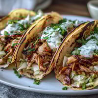 Light and flavorful Roasted Chicken Cabbage Tacos with tender shredded chicken, crisp cabbage slaw, and zesty lemon crema in warm tortillas.